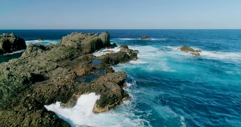 4k Slowmotion drone shot of powerful ocean waves crashing rocks in Tenerife Stock Footage 90284301