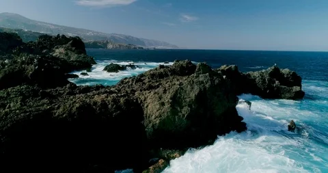 4k Slowmotion drone shot of powerful ocean waves crashing rocks in Tenerife Stock Footage 90288890