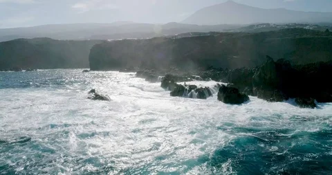 4k Slowmotion drone shot of powerful ocean waves crashing rocks in Tenerife Stock Footage 90303526