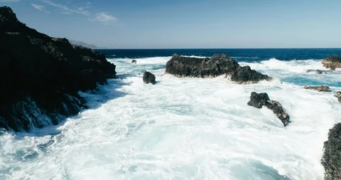 4k Slowmotion drone shot of powerful ocean waves crashing rocks in Tenerife Stock Footage 90304489