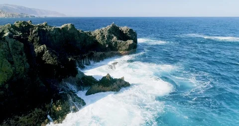 4k Slowmotion drone shot of powerful ocean waves crashing rocks in Tenerife Stock Footage 90306203
