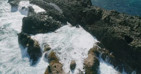 4k Slowmotion drone shot of powerful ocean waves crashing rocks in Tenerife Stock Footage 90306434