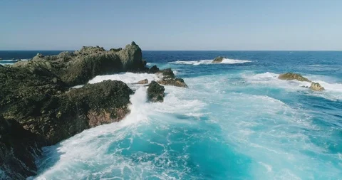 4k Slowmotion drone shot of powerful ocean waves crashing rocks in Tenerife Stock Footage 90306720
