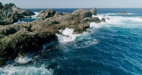 4k Slowmotion drone shot of powerful ocean waves crashing rocks in Tenerife Stock Footage 90307747