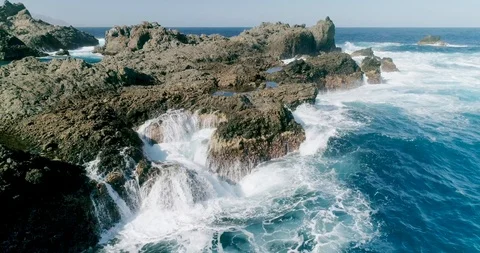 4k Slowmotion drone shot of powerful ocean waves crashing rocks in Tenerife Stock Footage 90307916