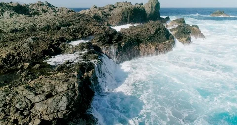 4k Slowmotion drone shot of powerful ocean waves crashing rocks in Tenerife Stock Footage 90308191