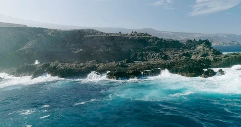 4k Slowmotion drone shot of powerful ocean waves crashing rocks in Tenerife Stock Footage 90308469
