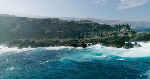 4k Slowmotion drone shot of powerful ocean waves crashing rocks in Tenerife Stock Footage 90308498