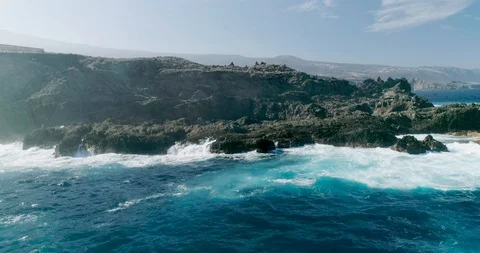 4k Slowmotion drone shot of powerful ocean waves crashing rocks in Tenerife Stock Footage 90308555
