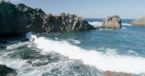 4k Slowmotion drone shot of powerful ocean waves crashing rocks in Tenerife Stock Footage 90308906