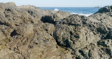 4k Slowmotion drone shot of powerful ocean waves crashing rocks in Tenerife Stock Footage 90309317
