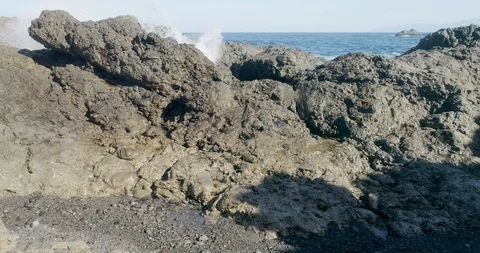 4k Slowmotion drone shot of powerful ocean waves crashing rocks in Tenerife Stock Footage 90309433