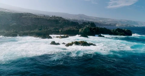 4k Slowmotion drone shot of powerful ocean waves crashing rocks in Tenerife Stock Footage 90309564