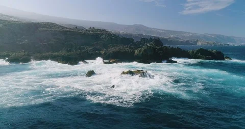4k Slowmotion drone shot of powerful ocean waves crashing rocks in Tenerife Stock Footage 90309593