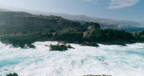 4k Slowmotion drone shot of powerful ocean waves crashing rocks in Tenerife Stock Footage 90309745