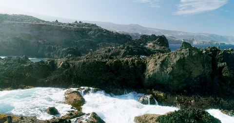 4k Slowmotion drone shot of powerful ocean waves crashing rocks in Tenerife Stock Footage 90309839