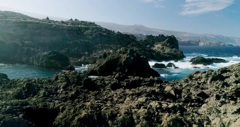 4k Slowmotion drone shot of powerful ocean waves crashing rocks in Tenerife Stock Footage 90309908