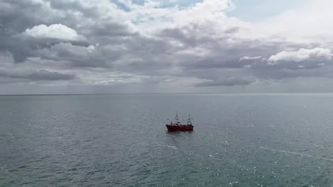 4K Small Boat on Open Sea Under Cloudy Sky Stock Footage 333411599