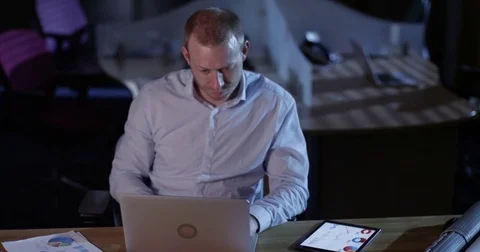 4K Small business owner working late in the office, going over the figures Stock Footage 76735061