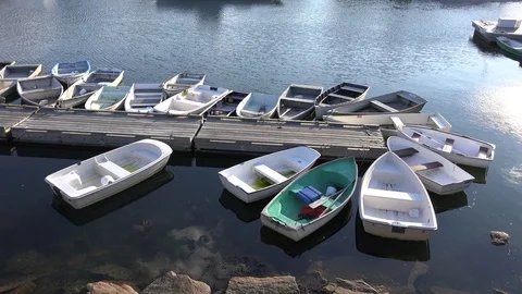 4K Small rowboat skiffs tied to fishing pier dock, calm waters 스톡 동영상 124564304