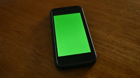4K SMARTPHONE ON TABLE WITH GREEN SCREEN Stock Footage 45203578