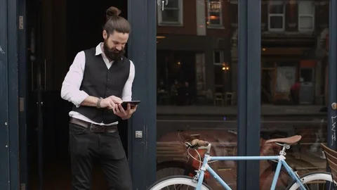 4K Smiling Bar Or Cafe Owner Standing Outside Shop With Computer Tablet Video stock 75704231