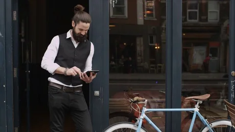 4K Smiling Bar Or Cafe Owner Standing Outside Shop With Computer Tablet Video stock 75704249