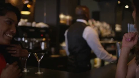 4K Smiling Bartender Prepares &amp; Serves Fresh Cocktails For Female Customers Stock Footage 75741454