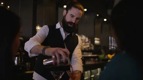 4K Smiling Bartender Prepares &amp; Serves Fresh Cocktails For Female Customers Stock Footage 75742136