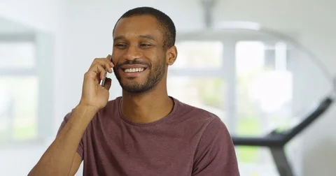 4K Smiling casual man making friendly phone call in modern home Stock Footage 82285823