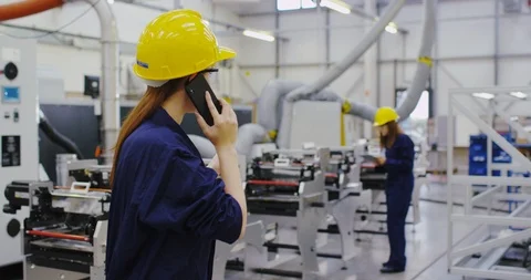4K Smiling factory operations manager making a phone call on the factory floor Stock Footage 101920094