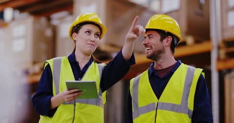 4K Smiling workers in distribution warehouse having a cheerful conversation Stock Footage 101946160