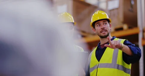 4K Smiling workers in distribution warehouse discussing storage &amp; logistics Stock Footage 101947341