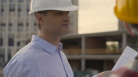 4K Smiling workers in distribution warehouse having a cheerful conversation Stock Footage 111930798