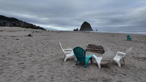4K smooth stabilized footage of empty Adirondack chairs across Cannon beach USA  Stock Footage 339422915