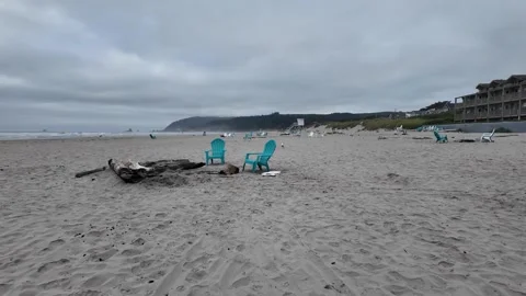 4K smooth stabilized footage of empty Adirondack chairs across Cannon beach USA  Stock Footage 339422992