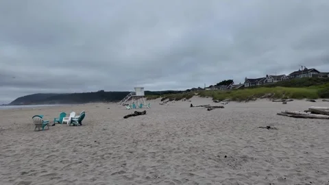 4K smooth stabilized footage of empty Adirondack chairs across Cannon beach USA  Stock Footage 339423636