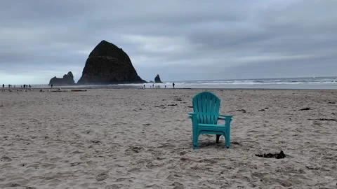 4K smooth stabilized footage of empty Adirondack chairs across Cannon beach USA  Stock Footage 339423721