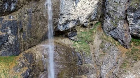 4k Smooth upward aerial drone flight a long a waterfall in a rocky mountain Video stock 80433510