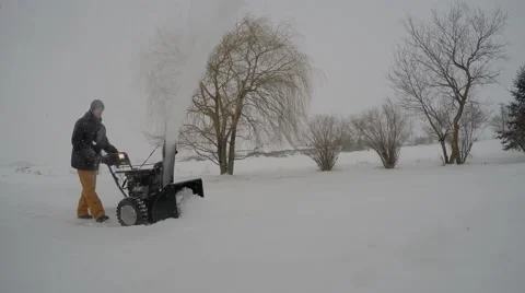 4k snowblower throws snow over camera Stock Footage 46502588