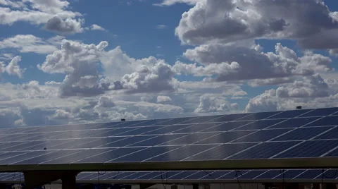 4K Solar Panels Shine Puffy Clouds Time Lapse Stock Footage