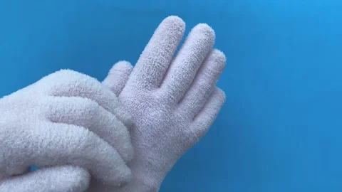 4k Spa gel moisturizing gloves on blue background. Stock Footage 156511020