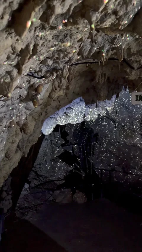 4K Sparkling Limestone Cave Formations Under Dramatic Lighting, Okinawa, Japan Stock Footage 345371597