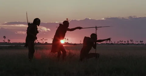 4K spectacular side view of three San people/Bushman in traditional dress at Stock Footage 95197444