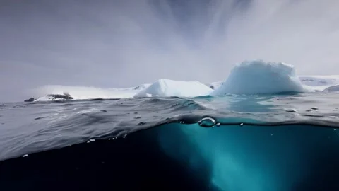 4K Split-View Iceberg Floating Polar Waters Submerged Ice Structure Stock Footage 332157249