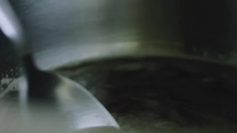 4K Spoon Stirring Dark Cola Mixture Inside a Metal Saucepan Video stock 342112911