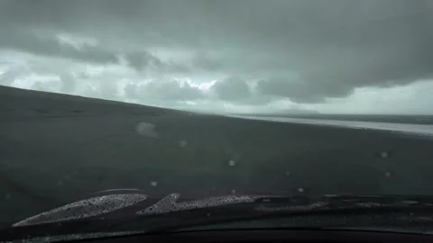 4K stabilized footage from the driver's perspective of driving on sand beach USA Stock Footage 328986035