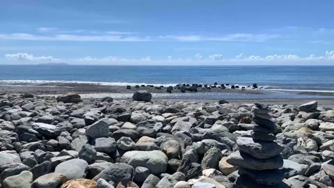 4k Stack of round smooth stones on a seashore Stock Footage 139879090