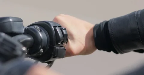 4k Starting motorcycle accelerating hand close up. Female biker twists throttle Stock Footage 85235024