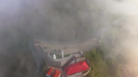 4K Static Aerial View of a Lighthouse, Foggy Coastal Road and Seaside Landscape Stock Footage 339235076